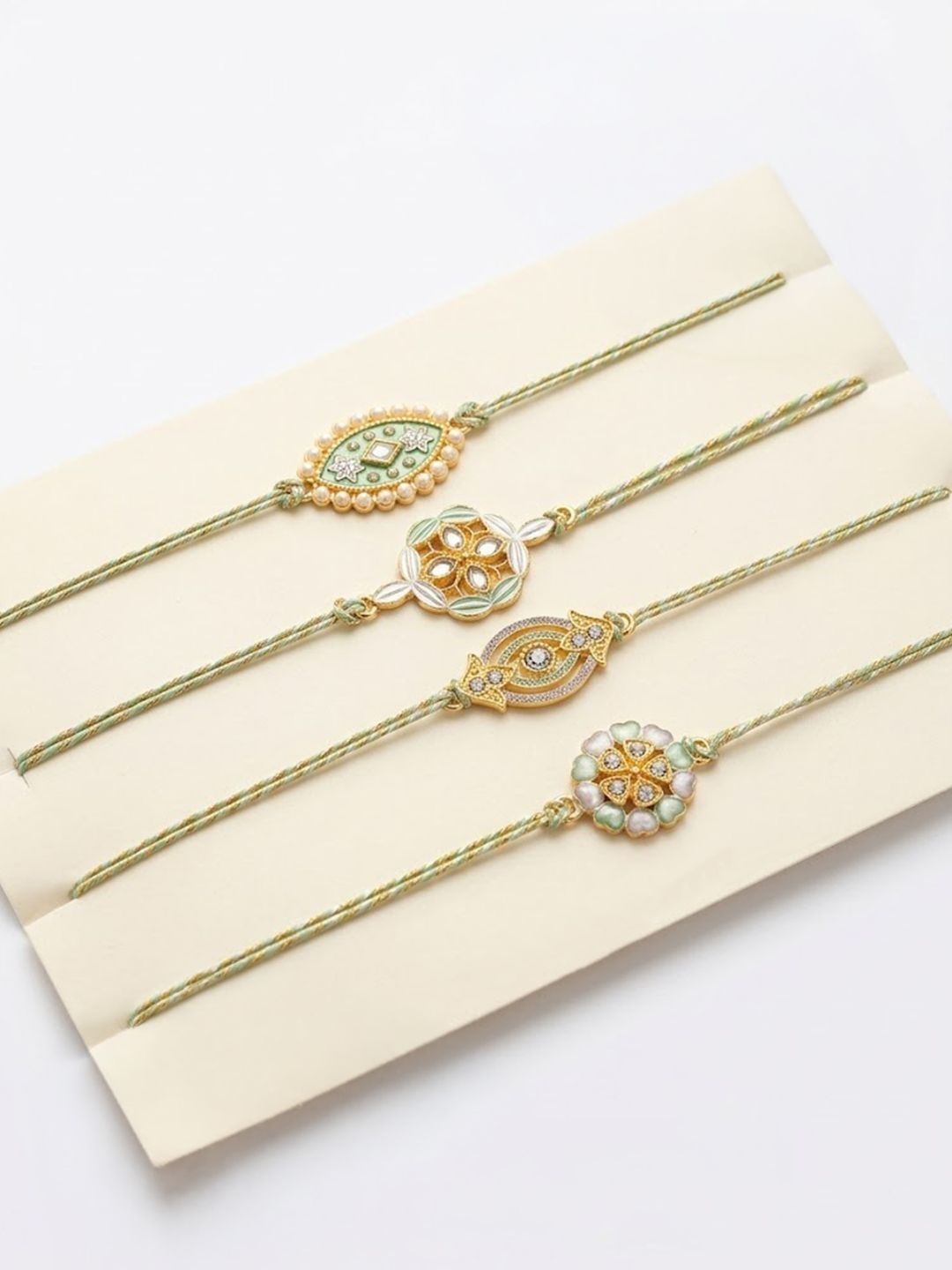 Anouk Set Of 4 White Artificial Stones & Green Thread Rakhi