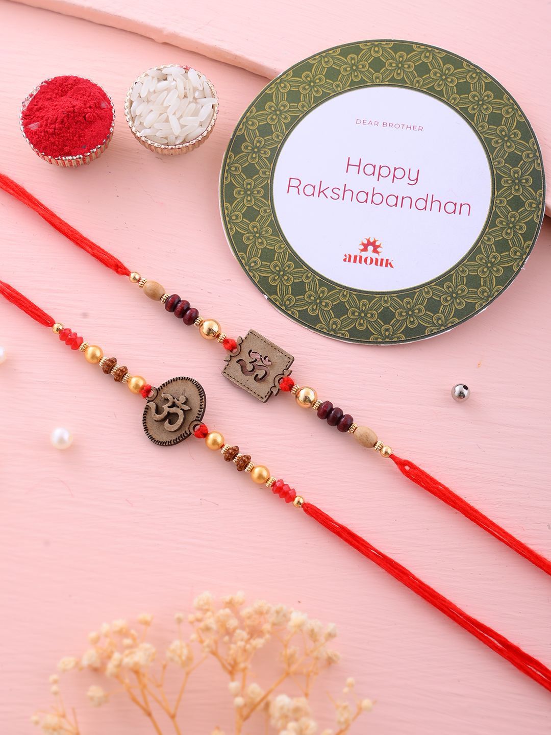 Anouk Set Of 2 Red Wooden Om Beaded Rakhi With Roli Rice & Greeting Card