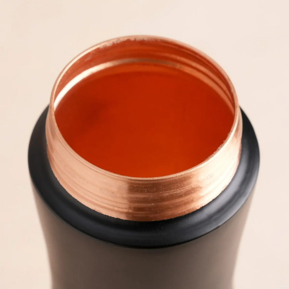 Copper water bottle by Isha Life, 700 ml capacity, with a sleek copper finish and ergonomic design.