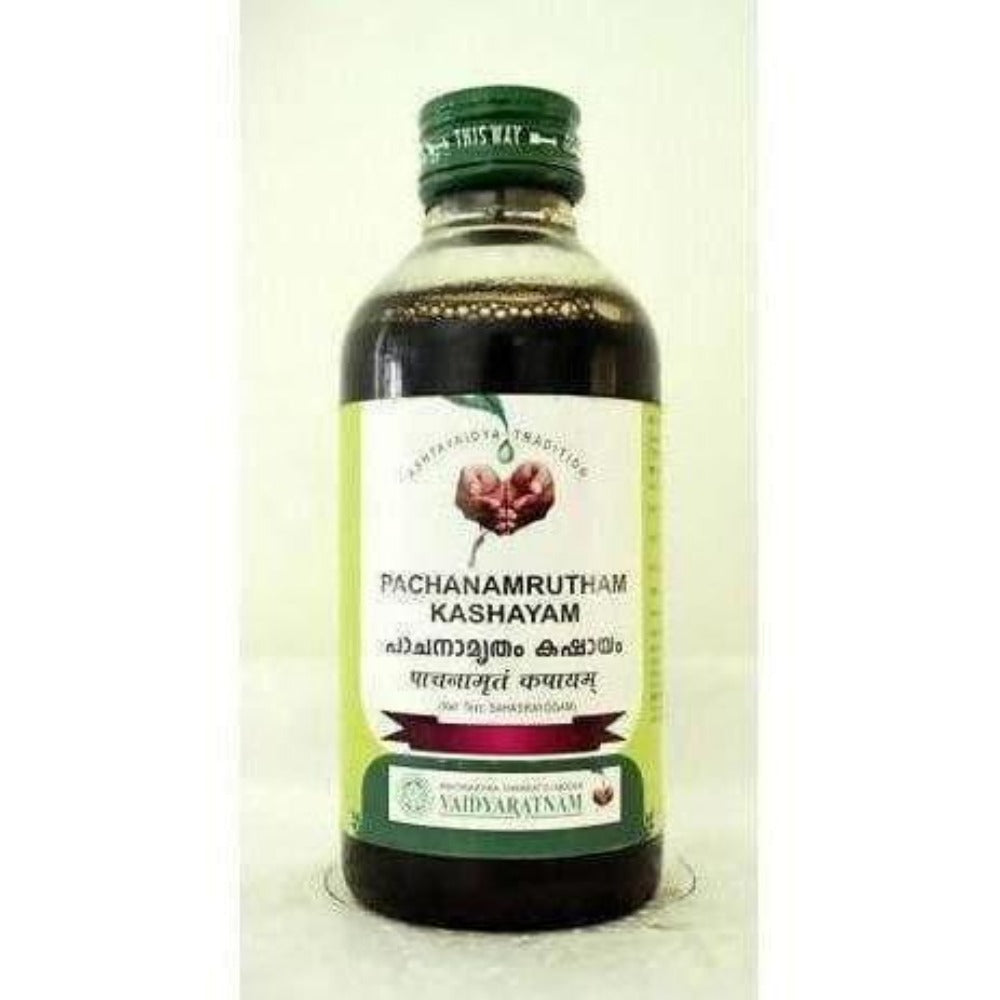 Vaidyaratnam Pachanamrutham Kashayam Ayurvedic syrup in a glass bottle with vetiver roots for wellness and digestion.