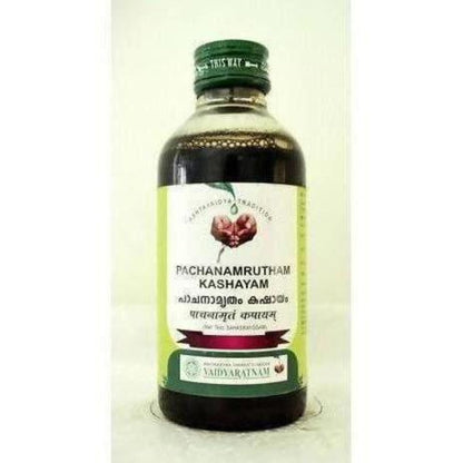 Vaidyaratnam Pachanamrutham Kashayam Ayurvedic syrup in a glass bottle with vetiver roots for wellness and digestion.