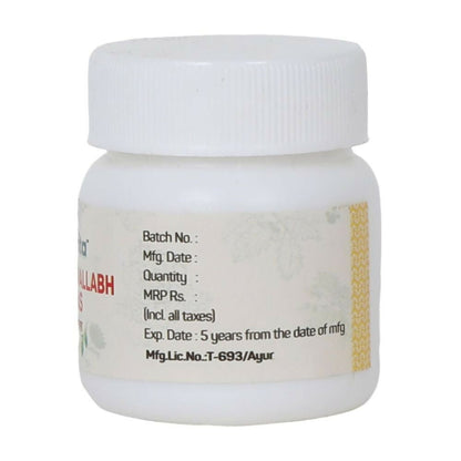 Amrita Nripativallabh Ras Ayurvedic tablets in a glass bottle with tablets visible inside, natural herbal supplement for health.