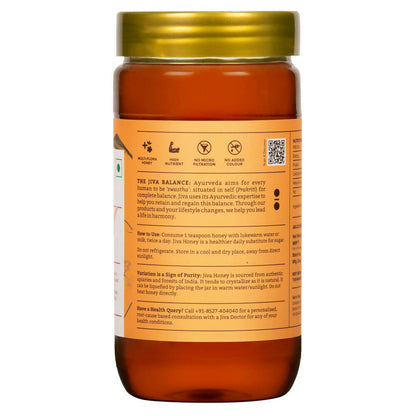 Jiva Ayurveda Honey jar showing golden honey with a label, natural sweet spread from Jiva Ayurveda for healthy eating.