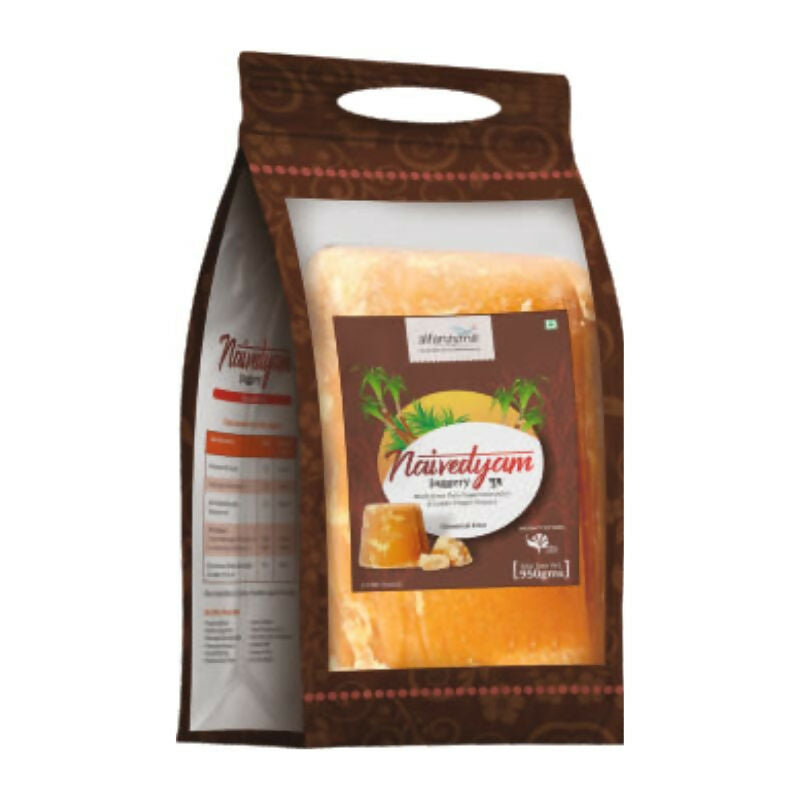 Naivedyam chemical-free jaggery cubes showing golden brown, unrefined jaggery pieces in a clear glass jar.