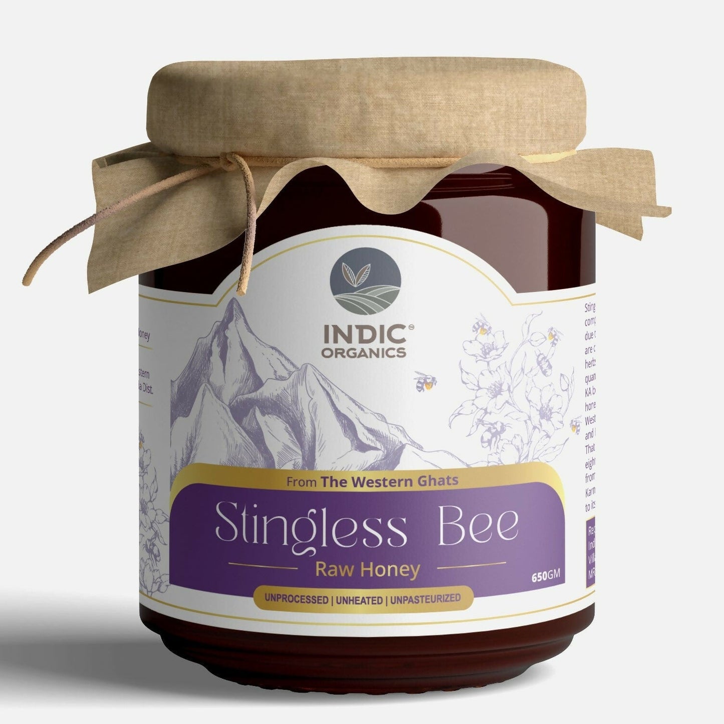Small jar of Indic Organics Stingless Bee Raw Honey from Western Ghats, placed on a wooden surface next to honeycomb.