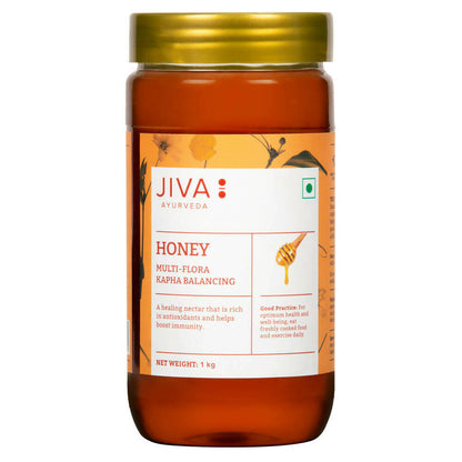 Jar of Jiva Ayurveda Honey, a natural sweet spread, with golden honey visible in a clear glass container.