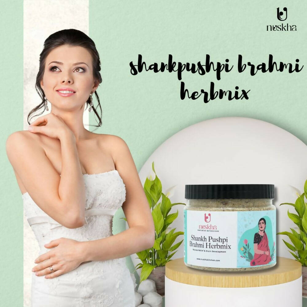 Nuskha ShankhPushpi Brahmi herbal health drink in a glass, showcasing the colorful liquid and fresh herbs used in the blend.
