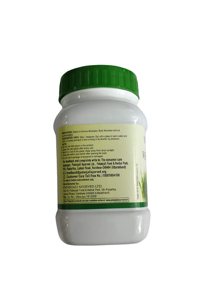 Patanjali wheat grass powder in a clear container, showing vibrant green powdered supplement for health and wellness.