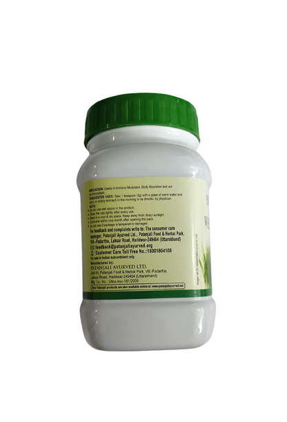 Patanjali wheat grass powder in a clear container, showing vibrant green powdered supplement for health and wellness.