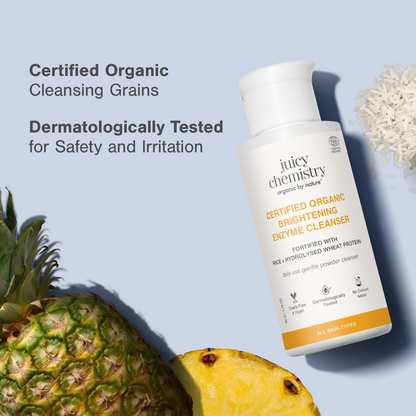 Juicy Chemistry Certified Organic Brightening Enzyme Cleanser in a clear bottle with a pump dispenser, showing the product label.