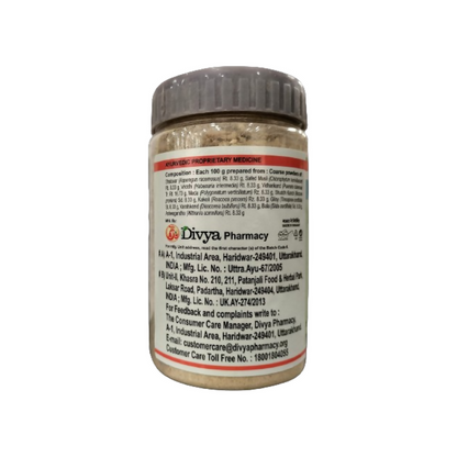 Patanjali Divya Immunogrit Kwath Ayurvedic herbal tea in a glass cup, featuring dried herbs and a golden-brown color.