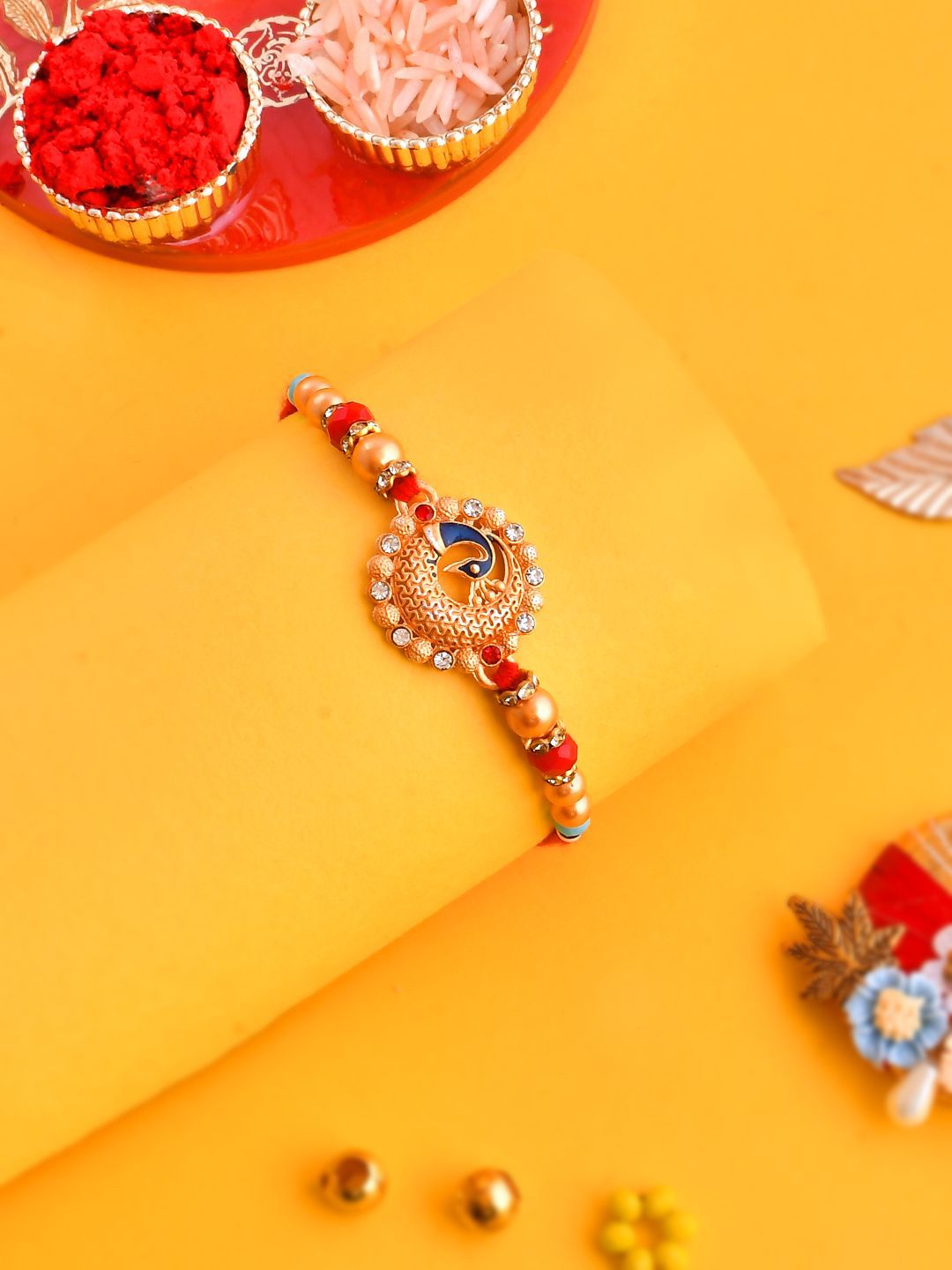 Anouk Gold Toned Beaded Peacock Patterned Rakhi With Roli Chawal & Greeting Card