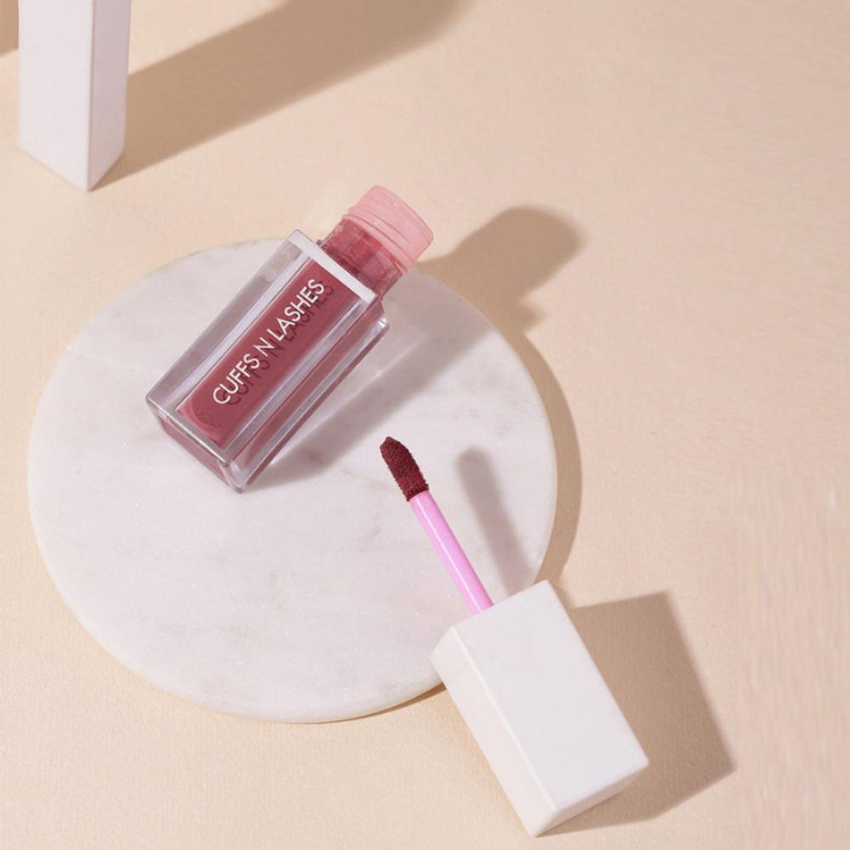 CUFFS N LASHES Matte Liquid Lipstick in shade 04 Duggs, featuring the product tube with a matte finish and sleek packaging.