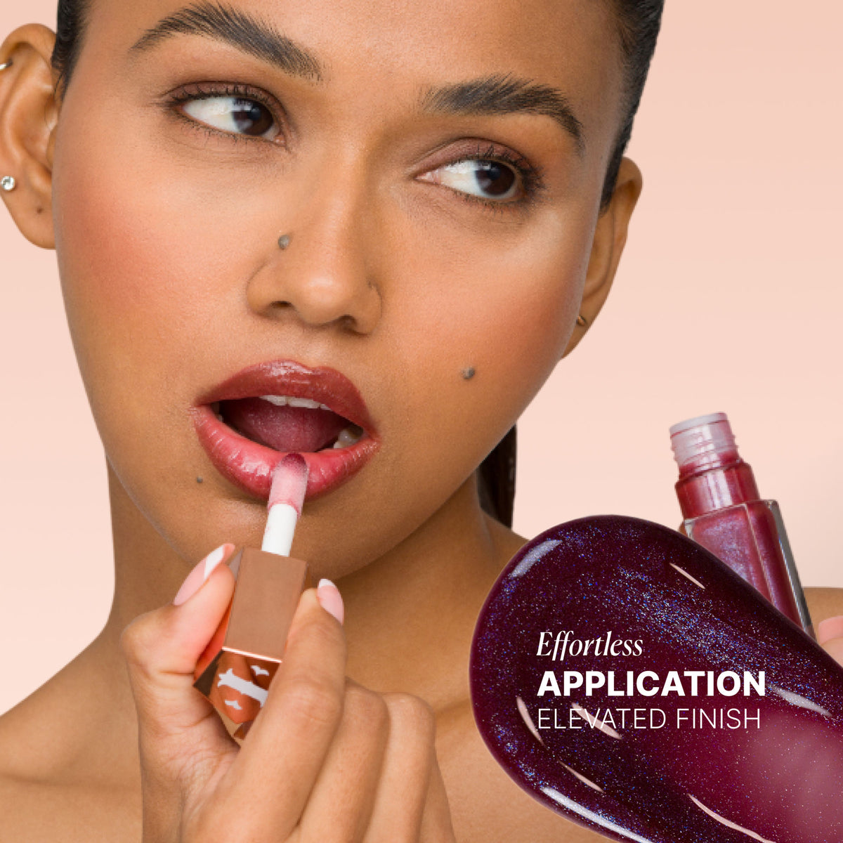IRIS COSMETICS Talk Glossy To Me! shimmer lip gloss in deep plum with subtle blue reflects light and adds shine to lips.