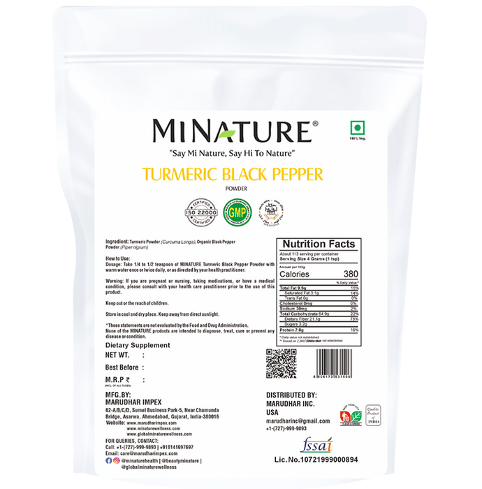 Organic miniature turmeric and black pepper Ayurvedic powder in a clear container, showing vibrant yellow and black spices.
