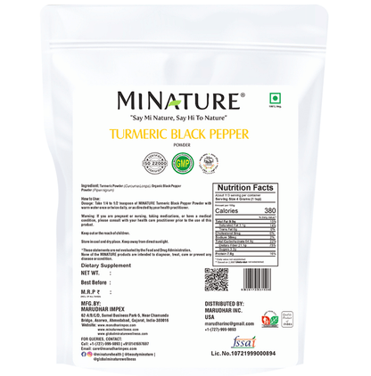 Organic miniature turmeric and black pepper Ayurvedic powder in a clear container, showing vibrant yellow and black spices.