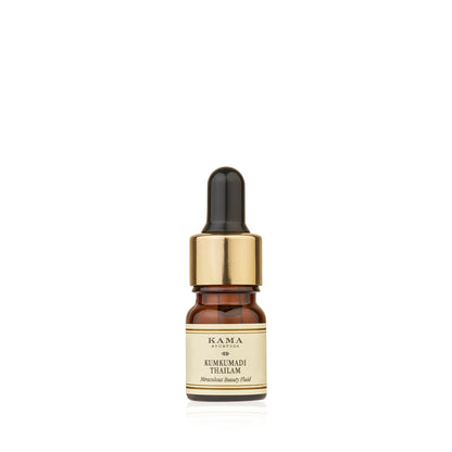Kama Ayurveda Kumkumadi Thailam Ayurvedic night serum in a glass bottle with a dropper for radiant skin.
