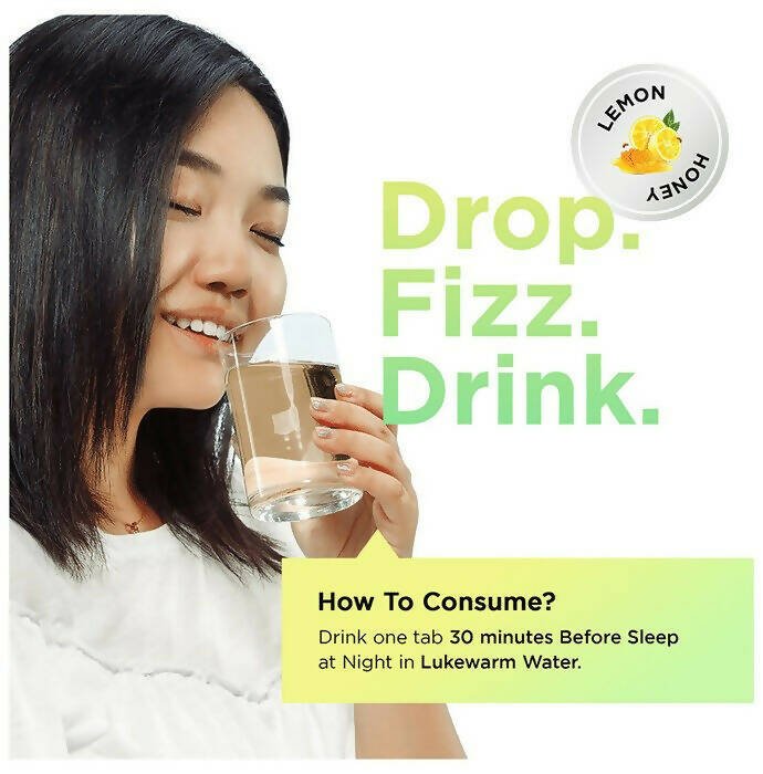 Auric Poop Easy Ayurvedic effervescent tablets dissolved in water, showing the tablet's packaging and the effervescent action.