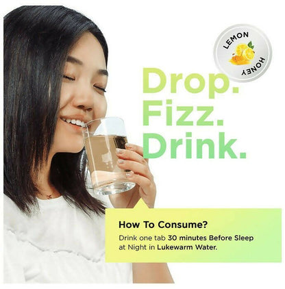 Auric Poop Easy Ayurvedic effervescent tablets dissolved in water, showing the tablet's packaging and the effervescent action.