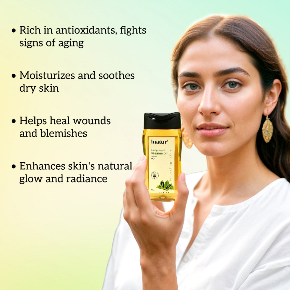 Inatur sesame oil bottle, 100% pure organic cold-pressed virgin sesame oil for skin and hair care, shown in a clear container.