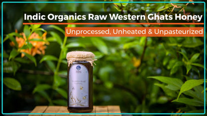 Small jar of Indic Organics Stingless Bee Raw Honey from Western Ghats, showcasing golden honey spread in a glass container.