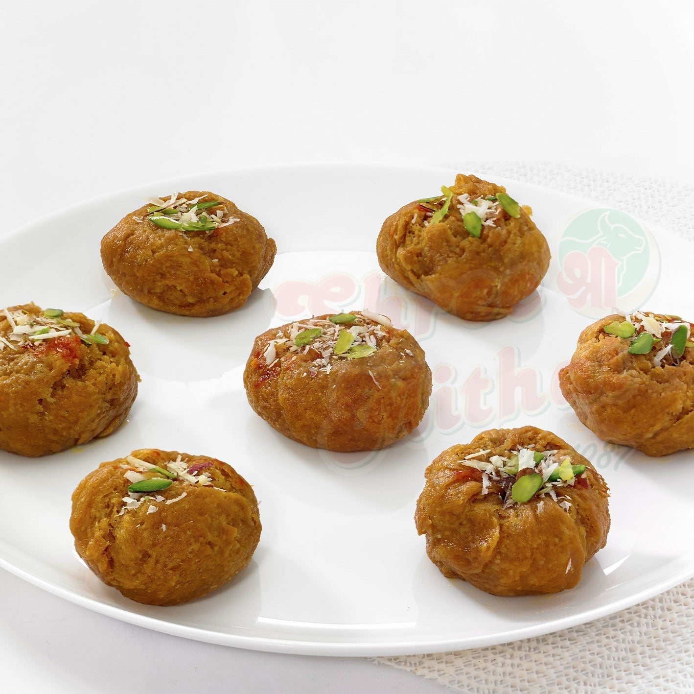 Shree Mithai Badhusha, North Indian sweet with golden-brown crispy layers and sugar glaze, served on a decorative plate.