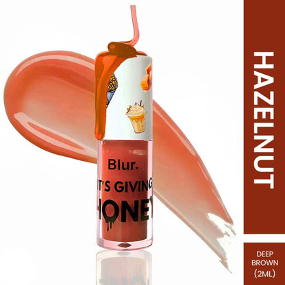 BLUR India's It's Giving Honey Lip Oil with Hazelnut, showing the lip oil bottle and natural hazelnut accents.