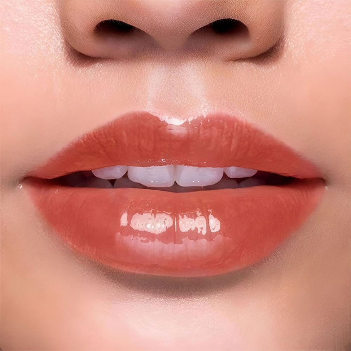 BLUR India It's Giving Honey Lip Oil in Hazelnut flavor, featuring a clear lip oil bottle with a gold cap and branding label.