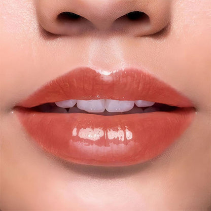BLUR India It's Giving Honey Lip Oil in Hazelnut flavor, featuring a clear lip oil bottle with a gold cap and branding label.