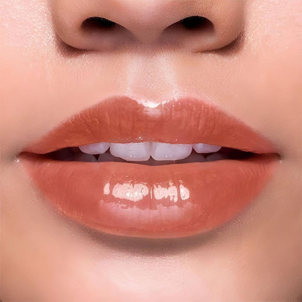 BLUR India It's Giving Honey Lip Oil in Caramel shade, featuring a sleek tube with glossy caramel-colored lip oil inside.