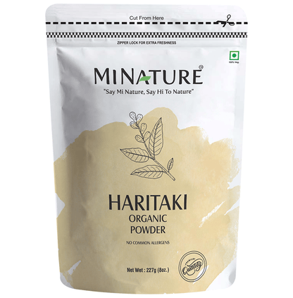 Organic Minature Haritaki powder in a natural setting, showcasing the fine, light-colored Ayurvedic powder in a clear container.
