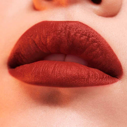 Estee Lauder Pure Color Whipped Matte Lip Color in Shock Me, vibrant coral lipstick with a smooth matte finish.