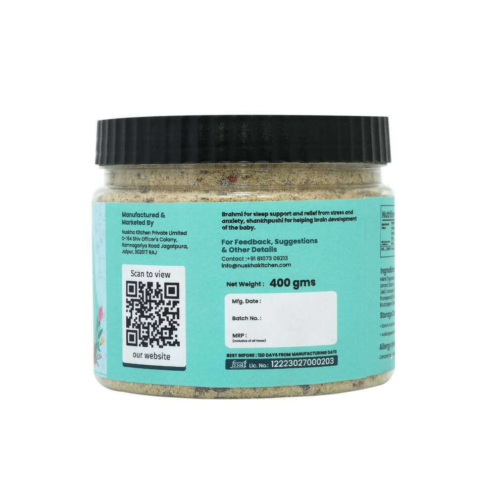 Nuskha ShankhPushpi Brahmi HerbMix health drink in a clear glass with fresh herbs and flowers, showcasing the herbal blend.