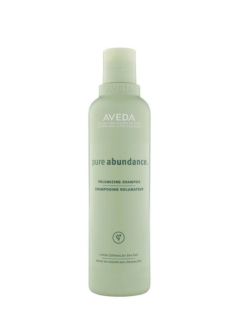 Aveda Pure Abundance Volumizing Shampoo bottle with white label and clear cap, designed for adding volume to hair.