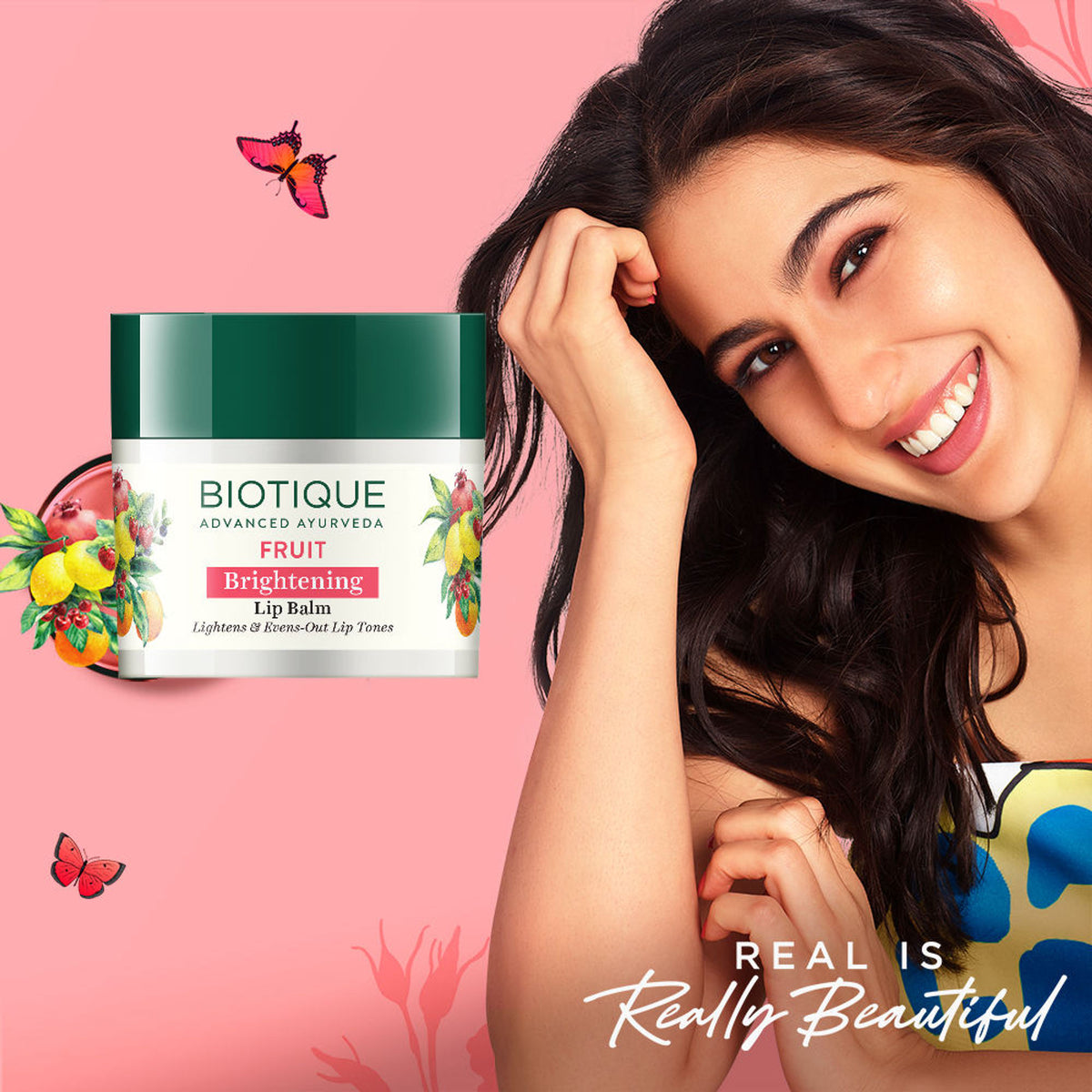 Biotique Fruit Brightening Lip Balm displayed in a tube with fresh fruit ingredients on the packaging.