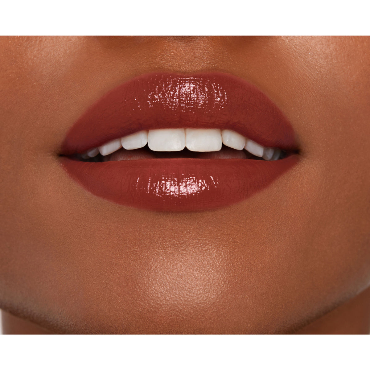 NARS Afterglow Sensual Shine Lipstick in Aragon, close-up of the lipstick tube showing the brand logo and rich, shiny finish.