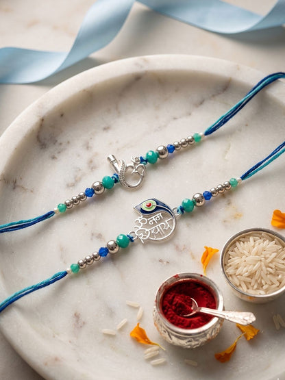 Anouk Set Of 2 Silver Toned Beaded Religious Thread Rakhi With Roli Chawal Chandan Mishri