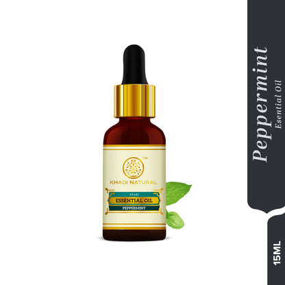 Khadi Natural Peppermint Essential Oil bottle with label, used for relieving headaches and nausea, with fresh peppermint leaves nearby.