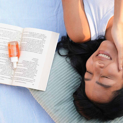 Aminu Radiance Face Oil with squalane and vitamin C, featuring a glass bottle with dropper for nourishing and brightening skin.