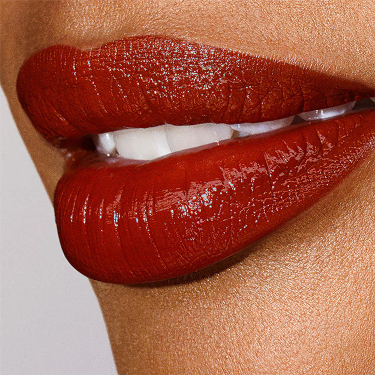 Estee Lauder Pure Color Explicit Slick Shine Lipstick in Heat Of The Moment, showcasing a vibrant lipstick bullet with shiny finish.
