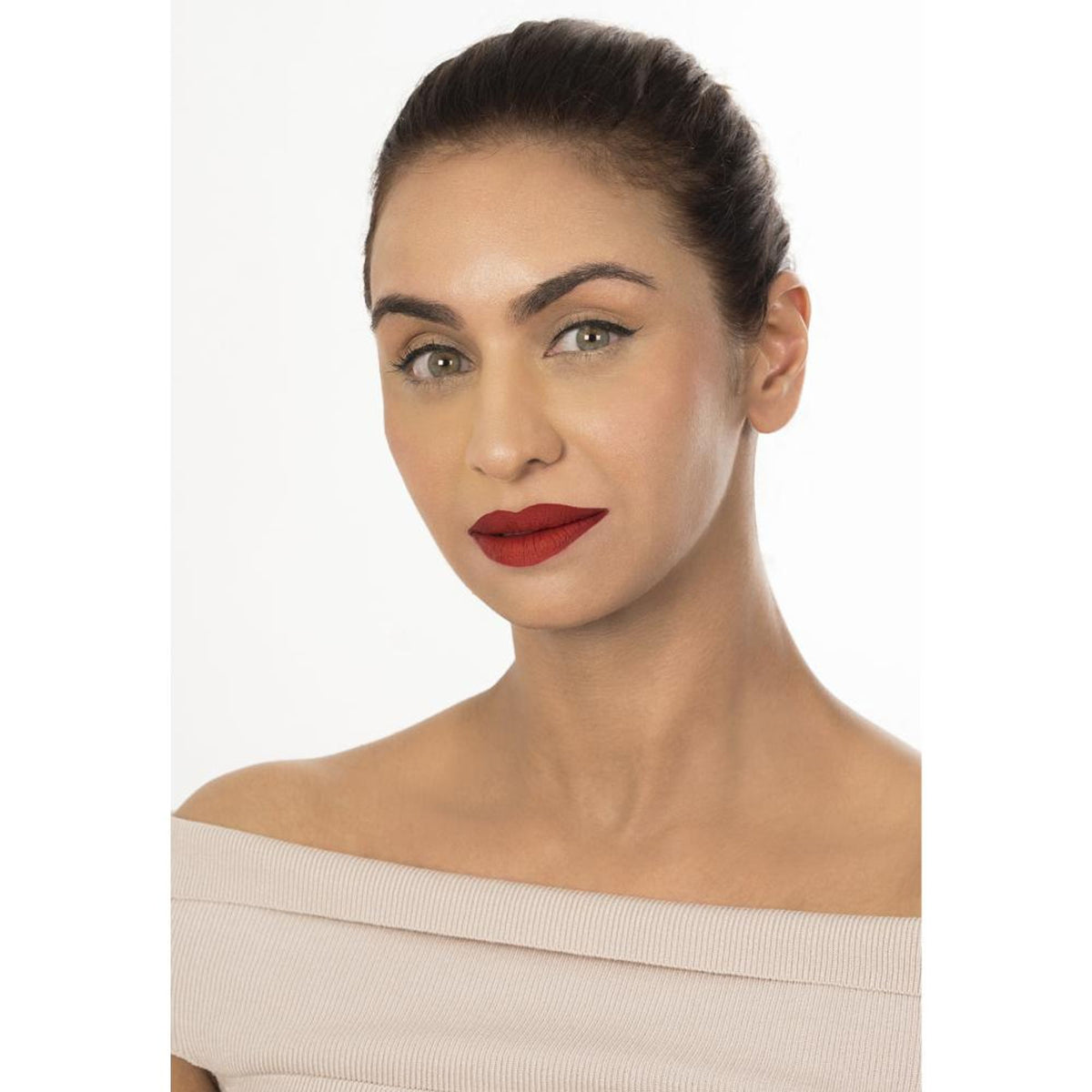 The Real Ritual Liquid Matte Lipstick in shade 107 Kaveri, featuring a sleek tube and applicator with rich, velvety lipstick visible.