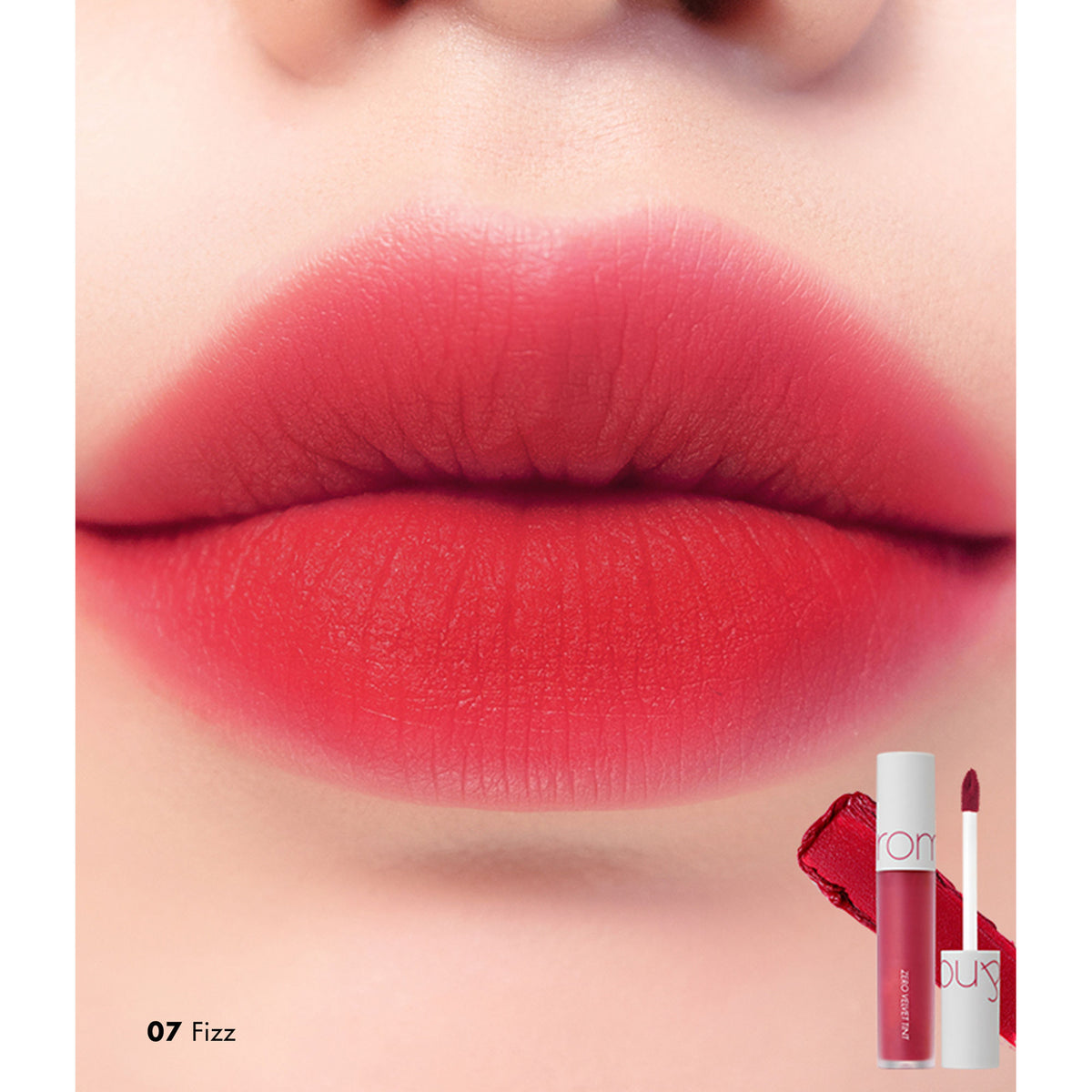 Rom&nd Zero Velvet Tint in shade 07 Fizz, featuring a sleek tube and applicator with vibrant pink-orange lipstick inside.