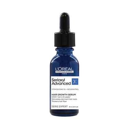 L'Oreal Professionnel Serioxyl Advanced Density Activator hair serum bottle with label and pump for thinning hair treatment.