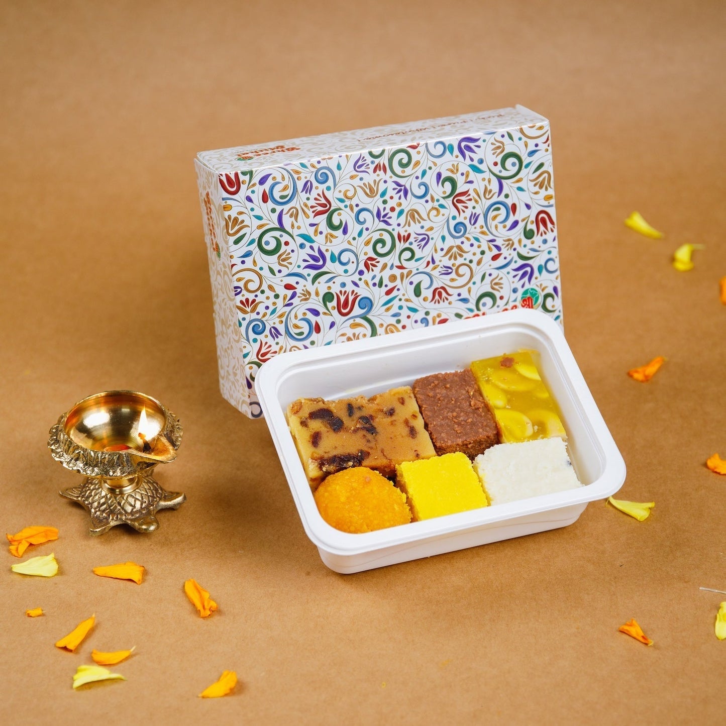 Assorted North Indian sweets from Shree Mithai, featuring vibrant indigo-colored traditional Indian confections on a plate.