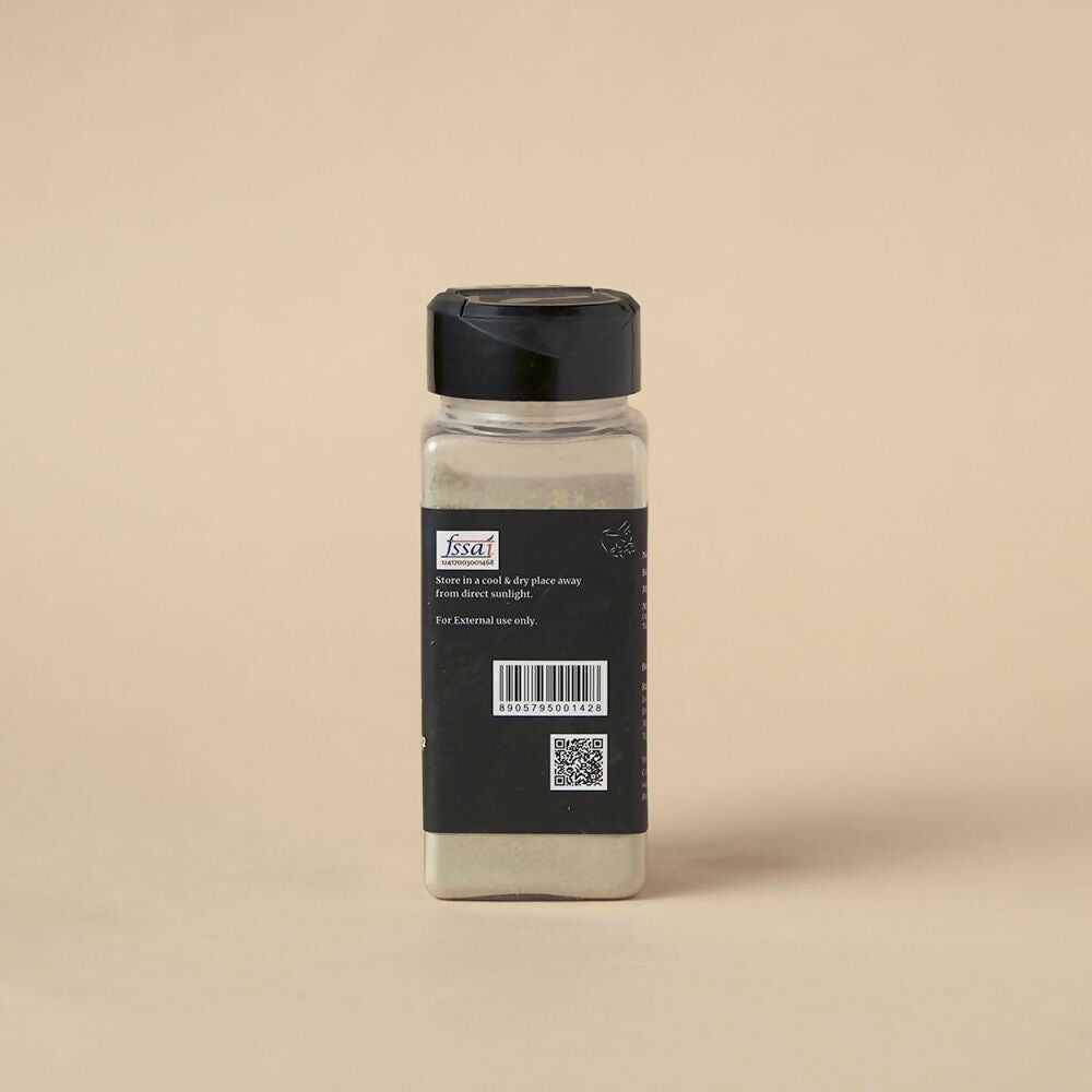 Isha Life herbal tooth powder and toothpaste combo in a natural setting, showcasing eco-friendly packaging and traditional herbal ingredients.