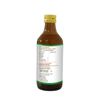 Pathak Ayurvedic Pharmacy Pittamla Kadha Ayurvedic syrup bottle with label and herbal ingredients in the background.