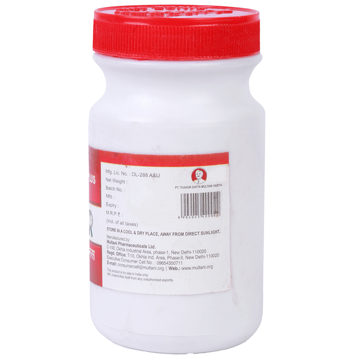 Multani Dantrakshak Plus Ayurvedic Tooth Powder in a jar, displaying natural ingredients and traditional packaging.