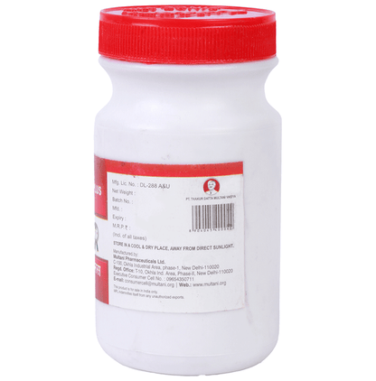 Multani Dantrakshak Plus Ayurvedic Tooth Powder in a jar, displaying natural ingredients and traditional packaging.