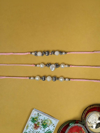 Anouk Set Of 3 White Pearls Thread Rakhi With Roli Chawal Chandan Mishri