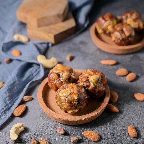 Vellanki Foods dry fruit laddu, traditional Indian sweet with mixed dried fruits and nuts, arranged on a plate.